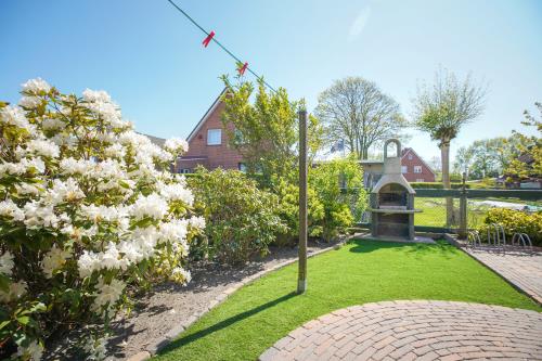 Borkum Ferienhaus Daheim - Wuldegapstraße 11 Aussenansicht Grilleck